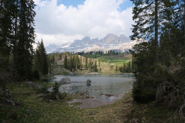 The fabulous alpine lake of Carezza in the Dolomites (Bolzano). Lovely place in the Italian Alps. Reflections in the water. Sunny spring day. Trentino Alto Adige