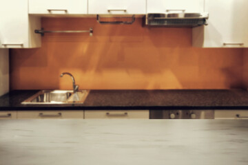 Blurred elegant marble tabletop with modern kitchen in the home background.