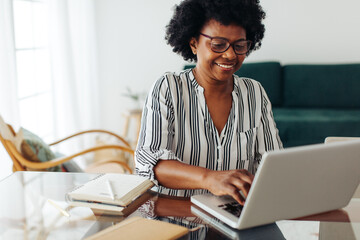 Woman working on laptop at home