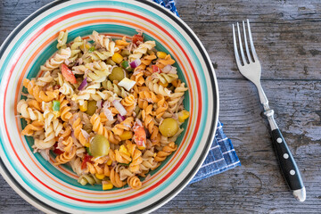 Pasta salad with tuna, egg, tomato, corn and olives