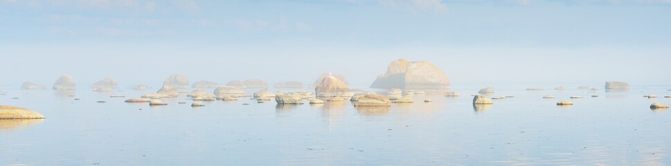 Rocks at the coast of Kasmu (captain's village), Estonia, in a white fog at sunset. Baltic sea....