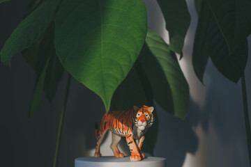 A tiger figurine among the leaves