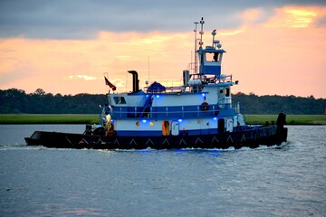 Tugboat cruising on the river at sunset St. Augustine, Florida, USA

