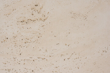 Rough textured warm latte tones stone tile surface close-up for textures and background work