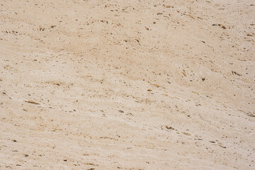 Rough textured warm latte tones stone tile surface close-up