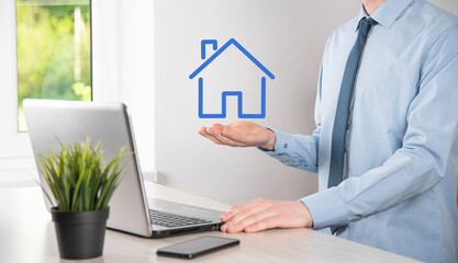 Real estate concept, businessman holding a house icon.House on Hand.Property insurance and security...