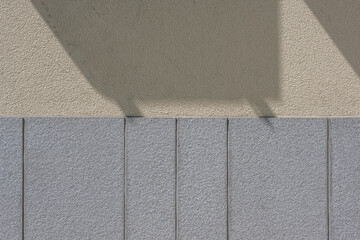Concrete and slate wall background in two tones with shadow from above