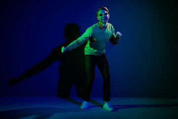 Fototapeta premium Full length body size photo man in sunglass dancing on discotheque chilling on holiday isolated on dark blue color background