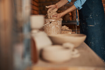 Woman hands preparing earthenware materials above the table in art studio