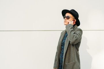 Queer speaking on smartphone on white background