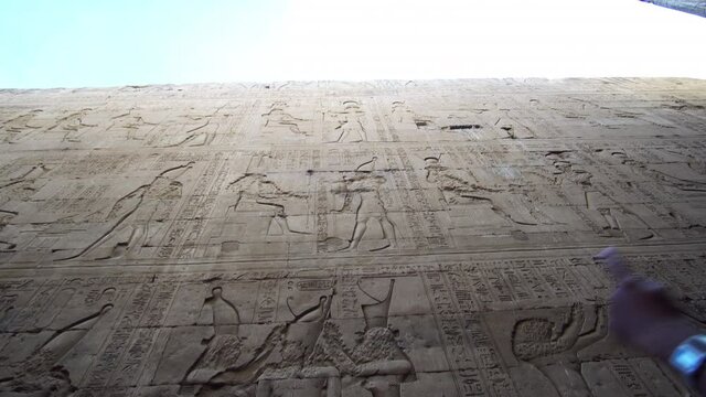 Egypt Edfu horus temple hieroglyphic tall wall all god face got destroyed from Christian war