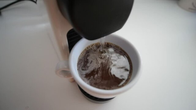 Cup Of Coffee Being Filed By Coffee Machine Close Up In Slow Motion