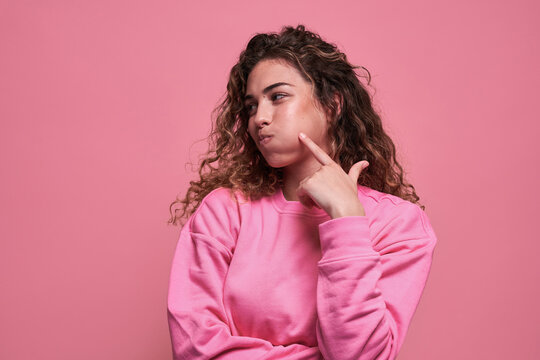 Charming teen puffing cheeks in studio