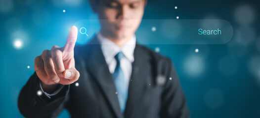 Businessman touch the search button on the virtual screen to find strategy ideas internet technology information network for business with dark background.