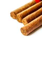 Group of brown cuban cigars isolated on white