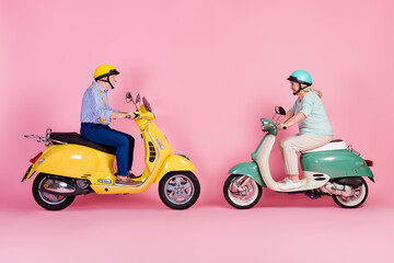 Fototapeta na wymiar Full size profile side photo of happy smiling mature couple ride drive moped traveling isolated on pink color background