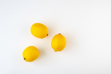 Whole lemons on a white background. Top view.