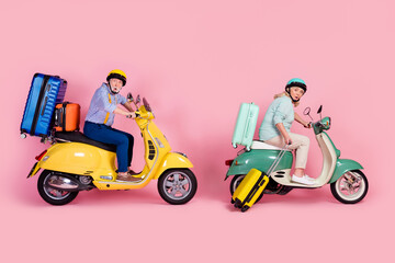 Full size profile side photo of shocked mature couple in helmet ride moped summer vacation isolated on pink color background