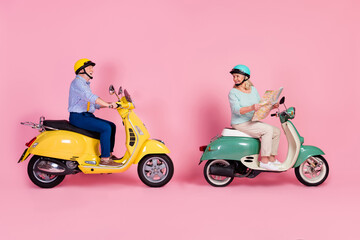 Full size profile side photo of smiling mature couple white grey hair ride moped hold map checking route isolated on pink color background - Powered by Adobe