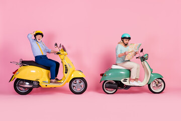 Full body profile side photo of aged friend ride scooter lost look map vacation tourism isolated over pink color background