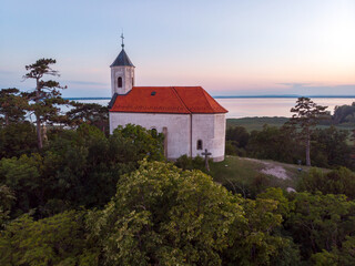 Fototapeta premium Aerial view of the hilltop chapel (St. Michael's Chapel) near Lake Balaton, at Vonyarcvashegy at sunset