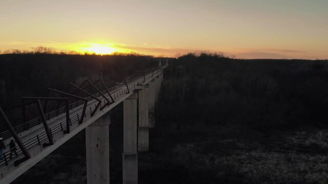 The sunset sets behind the High Tressel Trail Bridge bike path in Iowa