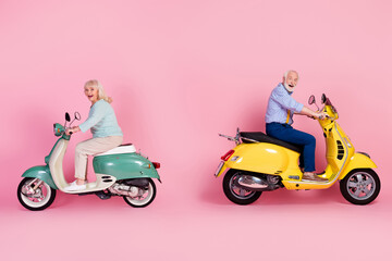 Fototapeta na wymiar Full size profile side photo of happy excited mature man and woman riding moped isolated on pink color background