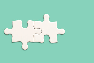 White jigsaw puzzle on green background, Find the right joined team correctly concept