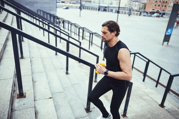 One young Caucasian athlete training outside on stairs