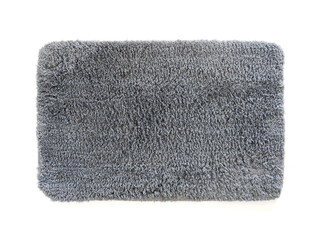 Fototapeta na wymiar Clean bathroom doormat isolated on white. Aerial view of microfiber bath mat with gray hair. Thick absorbent and non-slip mat. Antibacterial shower mat. Complement of bathroom, kitchen.