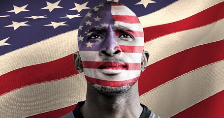 American flag over face of african american male athlete against american flag