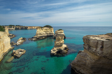 Fototapeta na wymiar Torre dell'Orso, with its high cliffs and blue sea, in Salento, Puglia, Italy