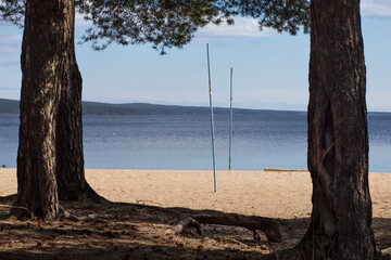 Scenic view on the beach of Onega lake with volleyball gates on the sand.