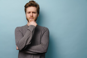 White ginger man with beard frowning and looking at camera