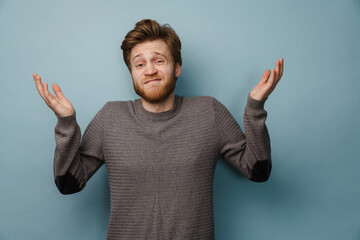 Fototapeta premium White ginger man with beard gesturing and looking at camera