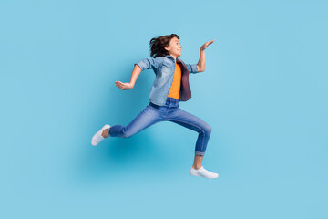 Full body profile side photo of young funny boy happy positive smile jump up fooling isolated over blue color background