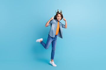 Full length photo of young boy happy positive smile point fingers crown king isolated over blue...