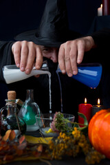 a male mage alchemist brews a potion. Halloween Holiday