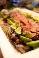 smoked fish sliced with lime slices at the buffet