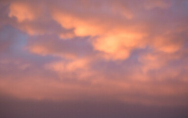 Naklejka na ściany i meble Sky with sunset. Pink and gold clouds. The lights of a sun. Dawn. Landscapes. Nature.
