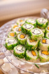 rolls with seaweed and cheese on a buffet table