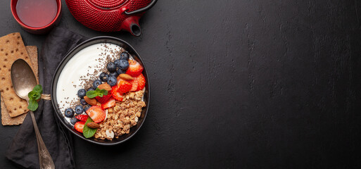 Healthy breakfast with bowl of granola, yogurt and fresh berries