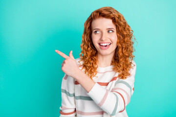 Portrait of attractive cheerful wavy-haired girl demonstrating copy blank space advert isolated over bright teal turquoise color background
