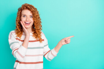 Portrait of attractive cheerful wavy-haired girl demonstrating copy space ad way isolated over bright teal turquoise color background