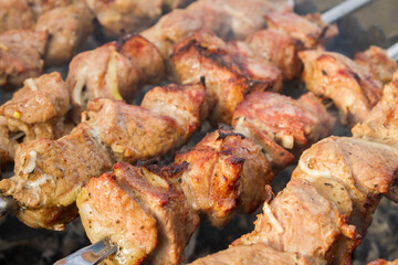 Shish Kebab made from pieces of pork is cooked on skewers on the grill