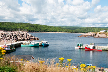 Fishing boats at dock in quiet inlet in maritime Canada