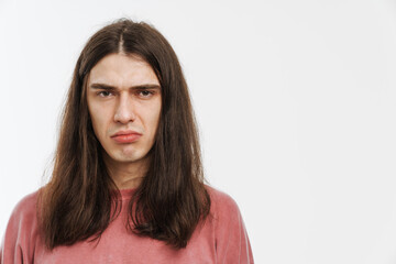 Young white man with long hair frown and looking at camera