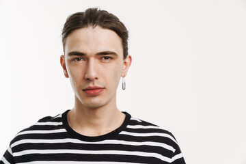Young white man with earring posing and looking at camera