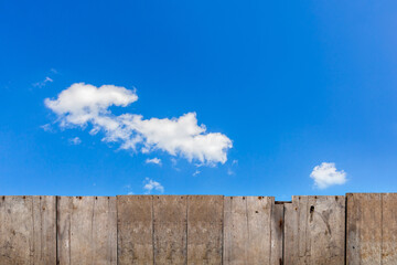 old brown wooden fence with sky background