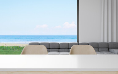 Fototapeta na wymiar Empty table with chair set and sofa of dining room near living area in modern house or luxury hotel. Minimal home interior 3d rendering with sky and sea view.